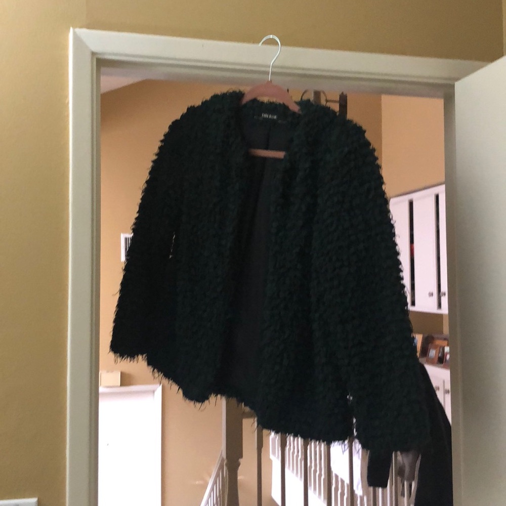 Green fluffy jacket.